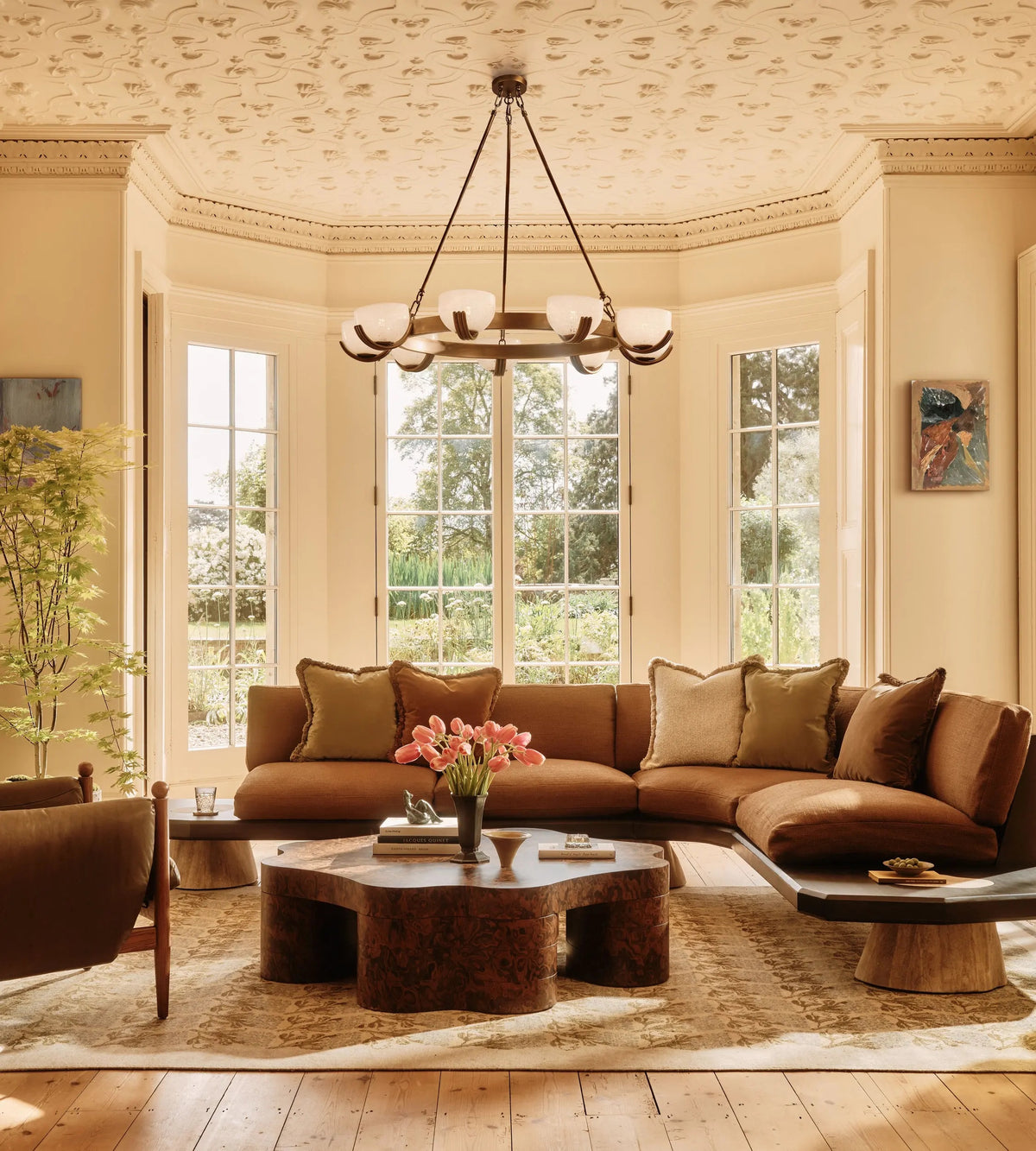 Elber brass chandelier with white confetti glass shades in a warm living room