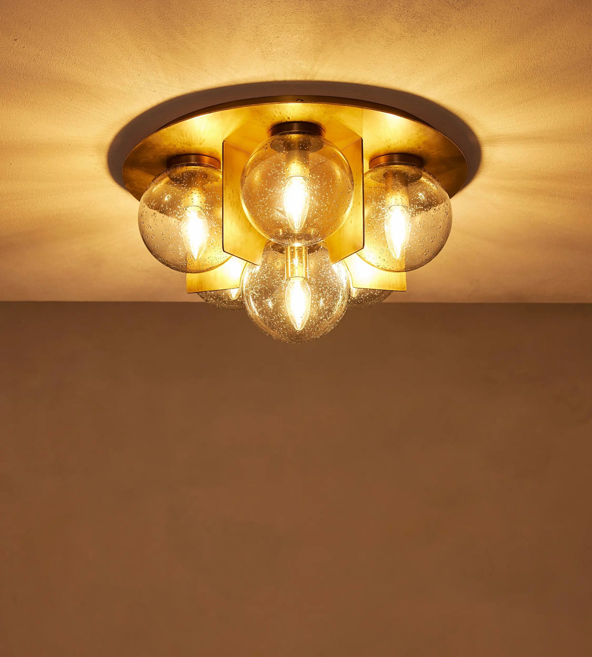 Lois flush mount ceiling light illuminated with six smoked bubble glass globes