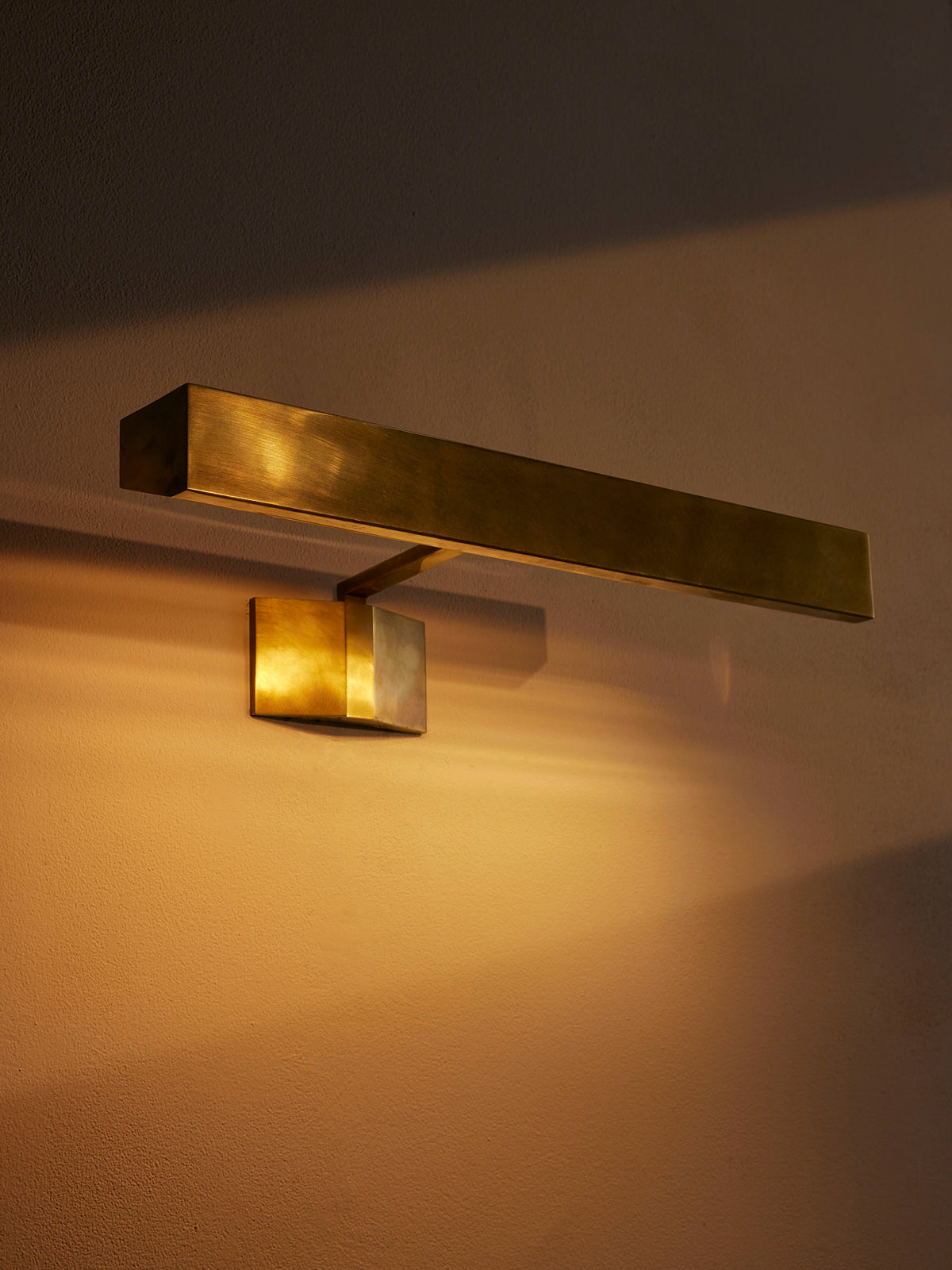 Angled view of the Enrica 18-inch adjustable brass picture light