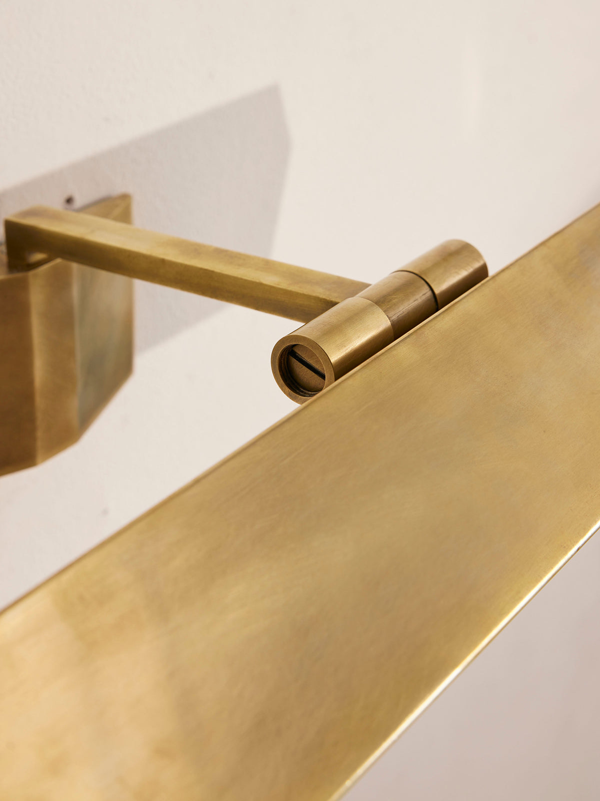 Close-up of the Enrica picture light adjustable brass shade joint