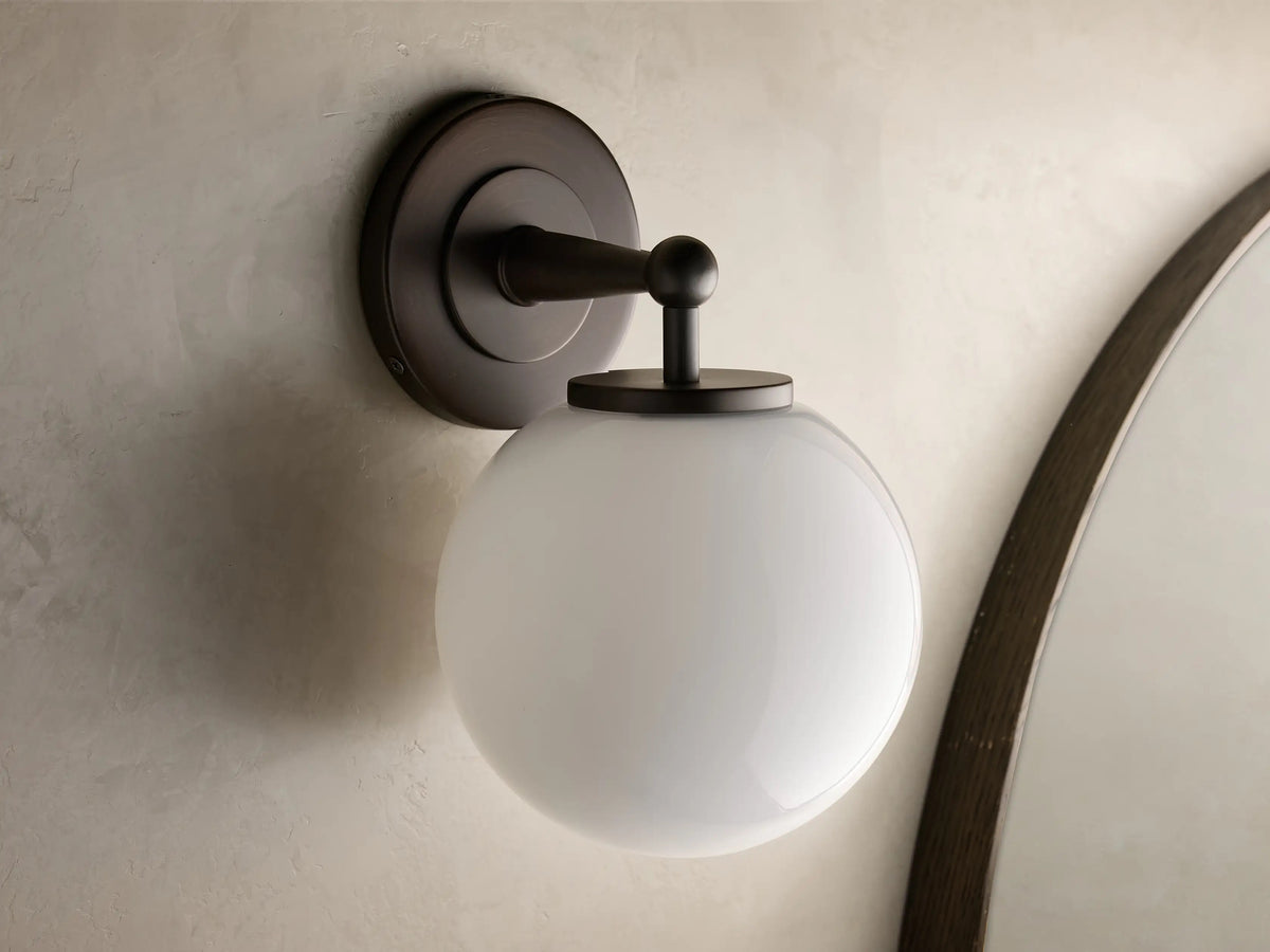 Fulton antique bronze sconce mounted downward with a mouth-blown milk glass globe