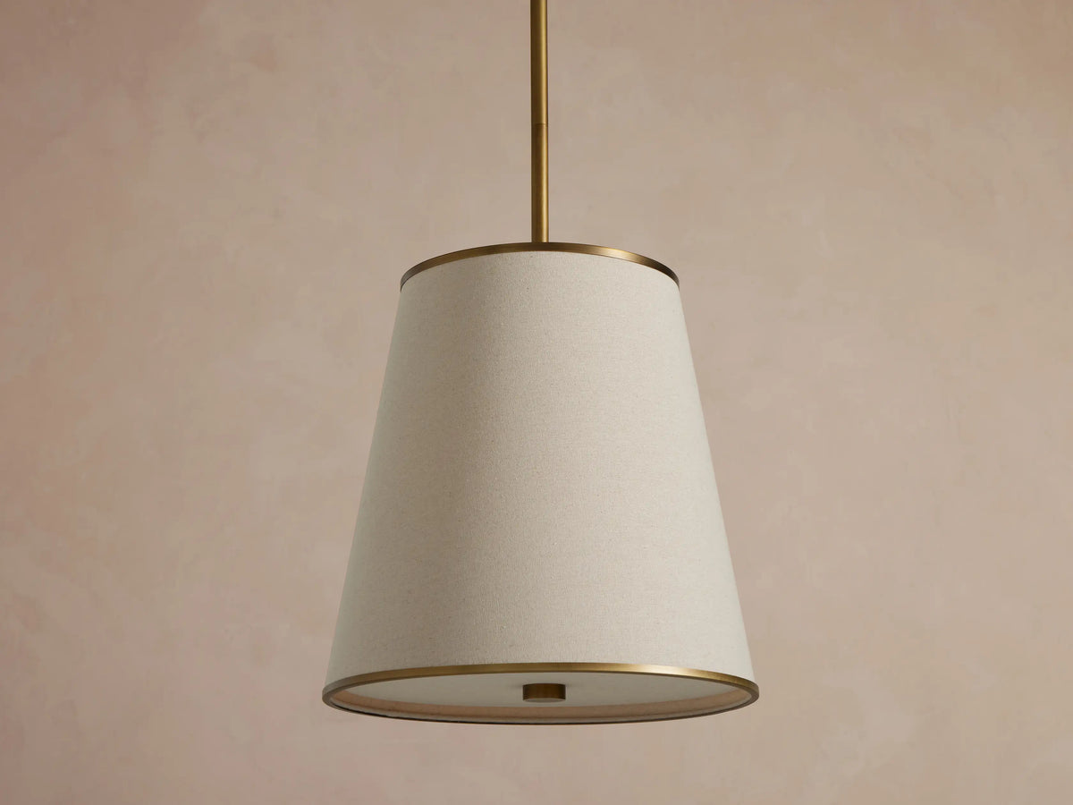 Adria Flax Pendant hanging against a warm textured wall