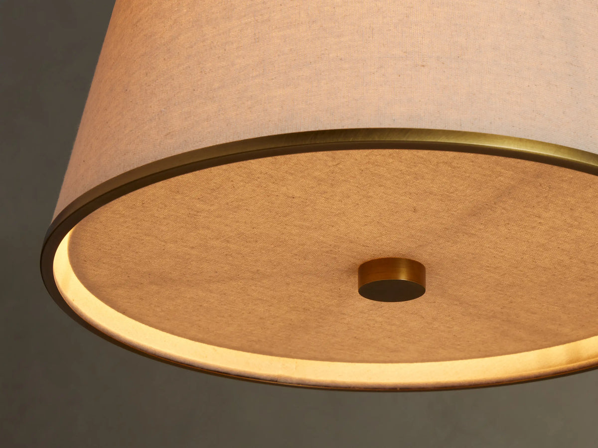 Close-up of Adria flax fabric shade and antique brass-tone rim