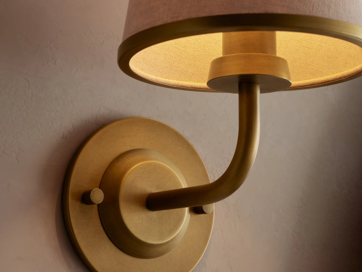 Close view of Adria Flax Sconce shade and brushed brass finish