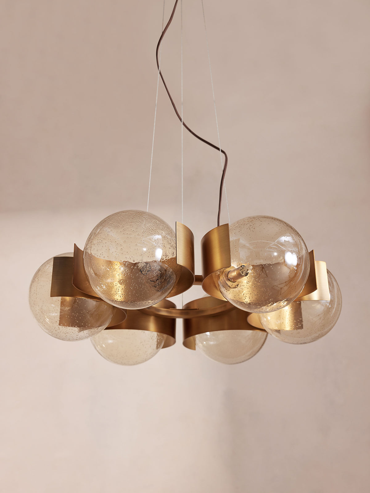 Close-up of the champagne glass globe and antiqued brass finish