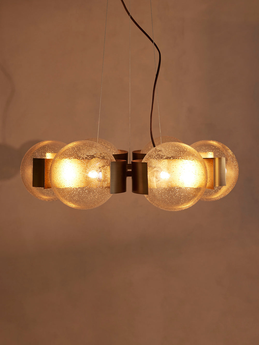 Allis chandelier with six illuminated champagne glass globes, front view