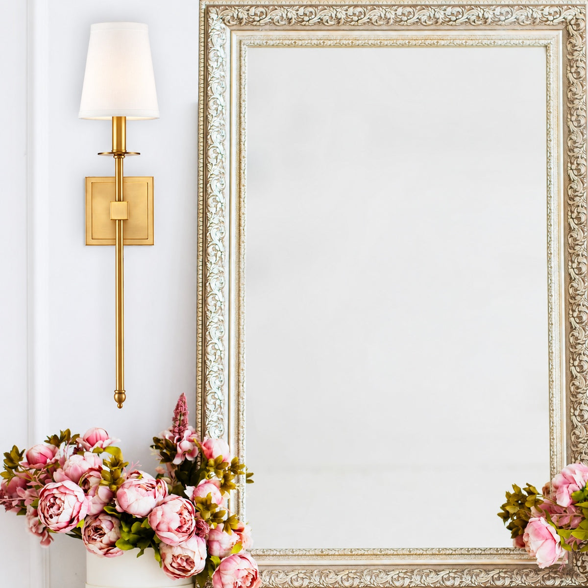 Warm brass Belmont Fabric Sconce installed beside a decorative mirror