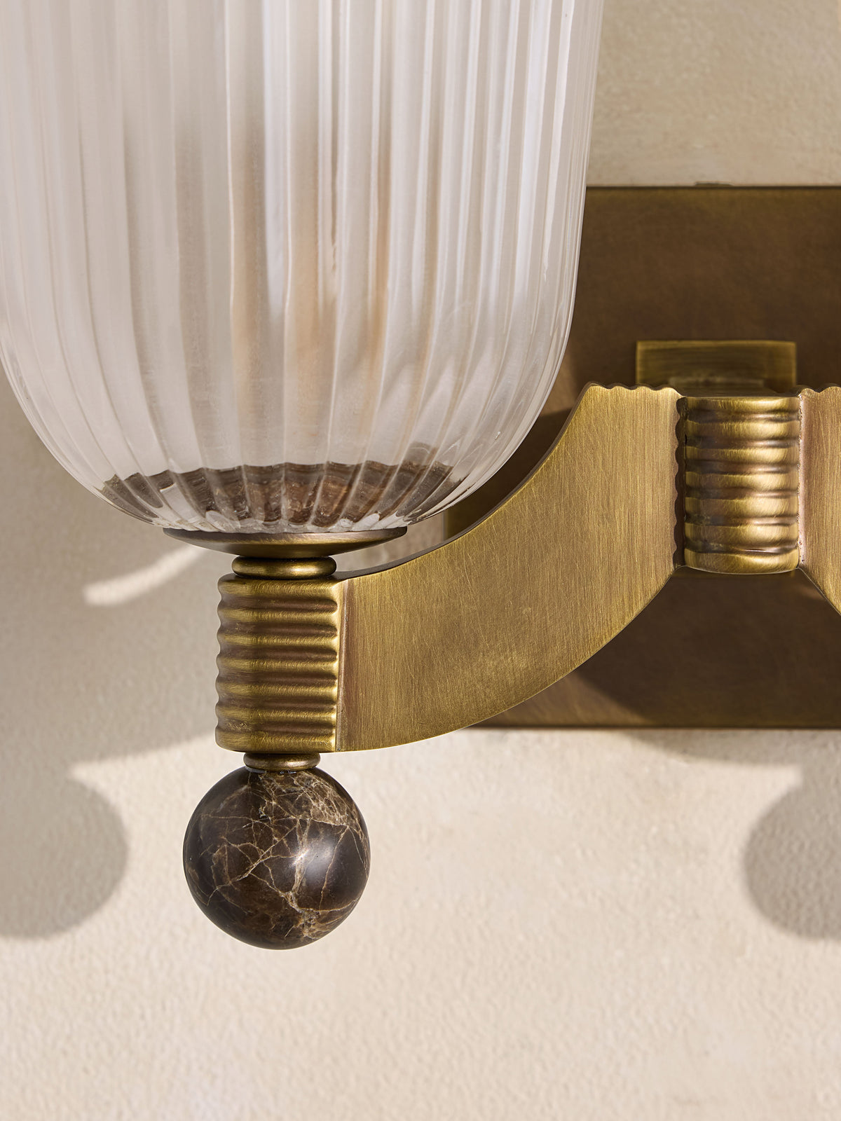 Ribbed glass and marble detail of Colette wall sconce