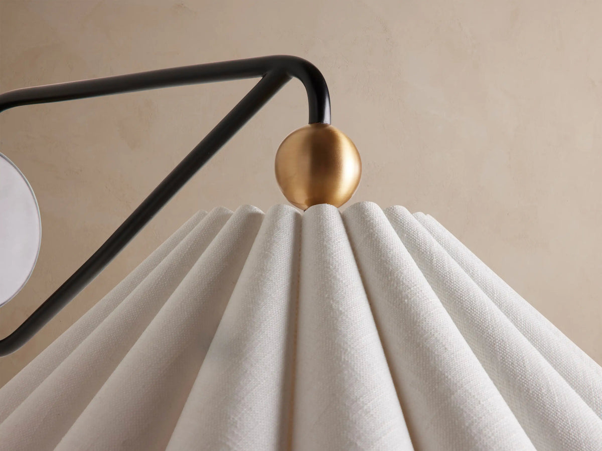 Close-up of Haylen sconce pleated shade and brass accent