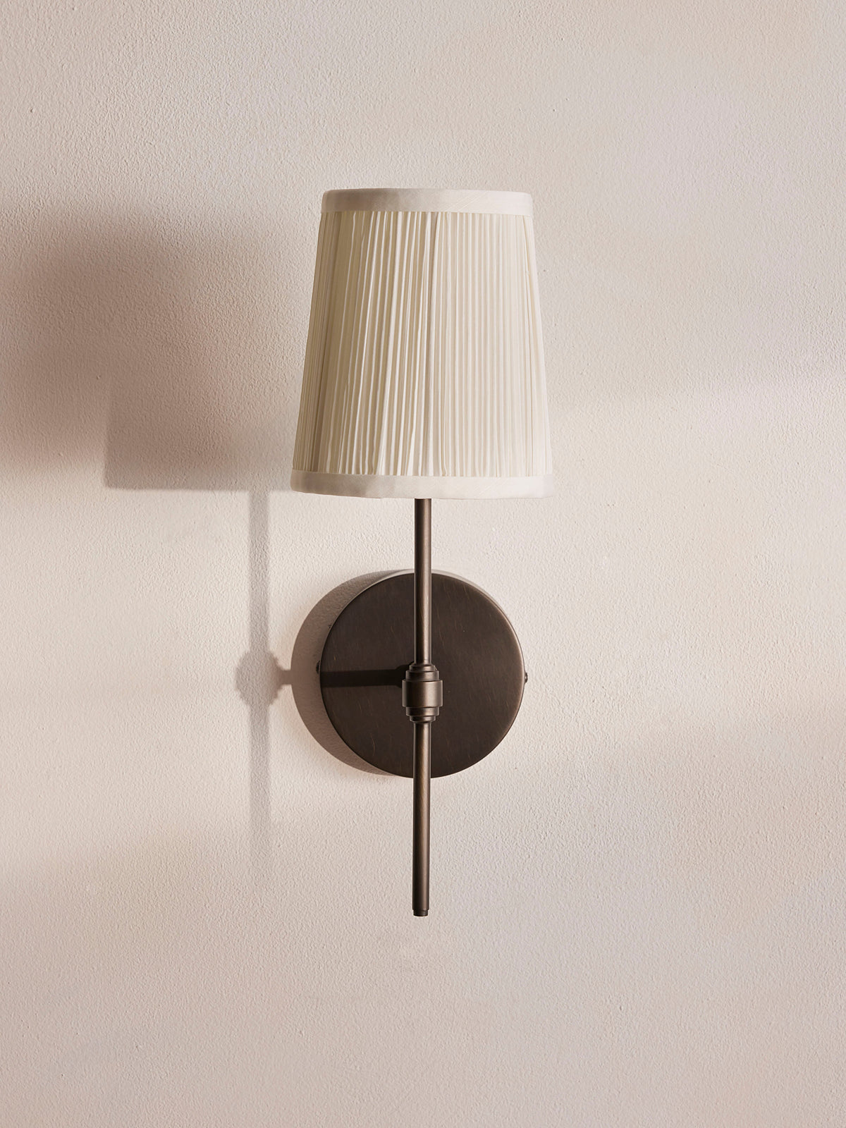 Isobella wall sconce unlit front view with ivory pleated shade