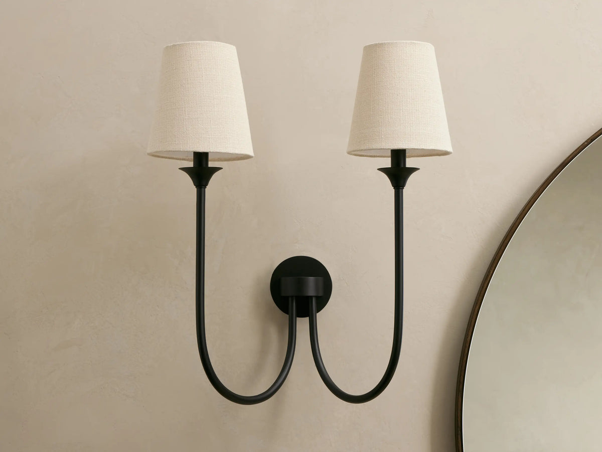 Saige bronze double wall sconce front view, two off-white fabric shades