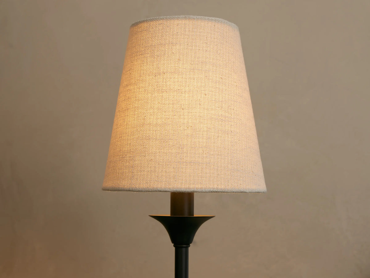 Close-up of the off-white fabric shade on Saige bronze wall sconce