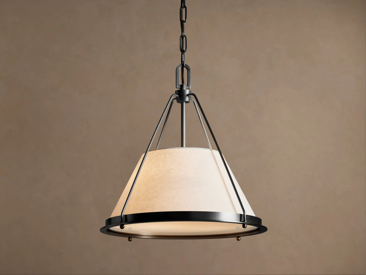 Shelton bronze pendant with tapered linen shade illuminated, front view