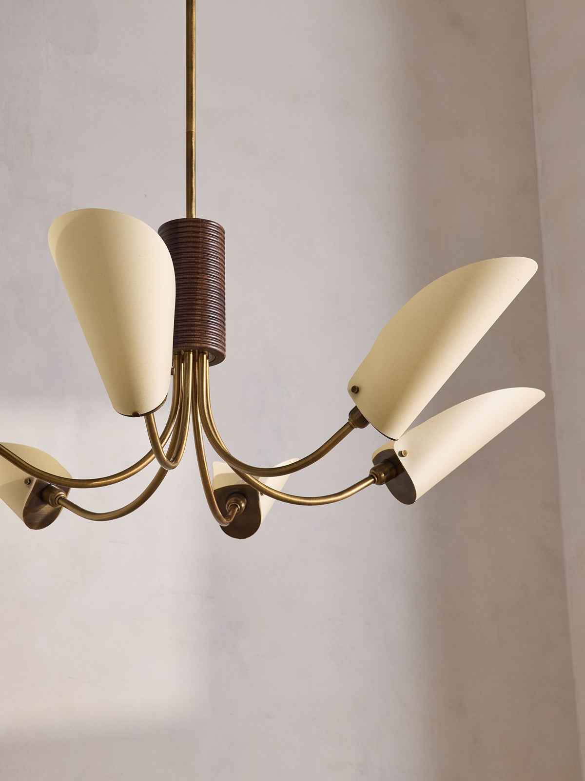 Truman walnut column and curved brass arm detail