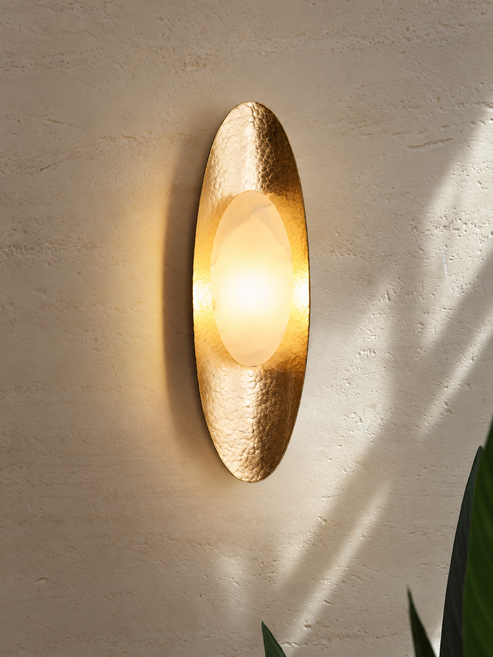 Close view of illuminated gold and marble wall sconce