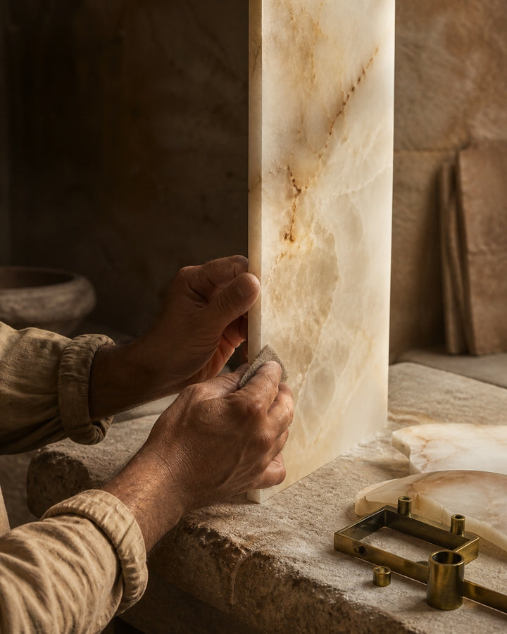 Artisan hand-finishing a translucent Spanish alabaster panel for a lighting fixture